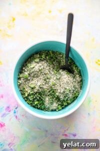 15 Homemade Seasoning Recipes to Transform Your Cooking 16 blue bowl filled with seasonings for ranch mix and tiny black spoon
