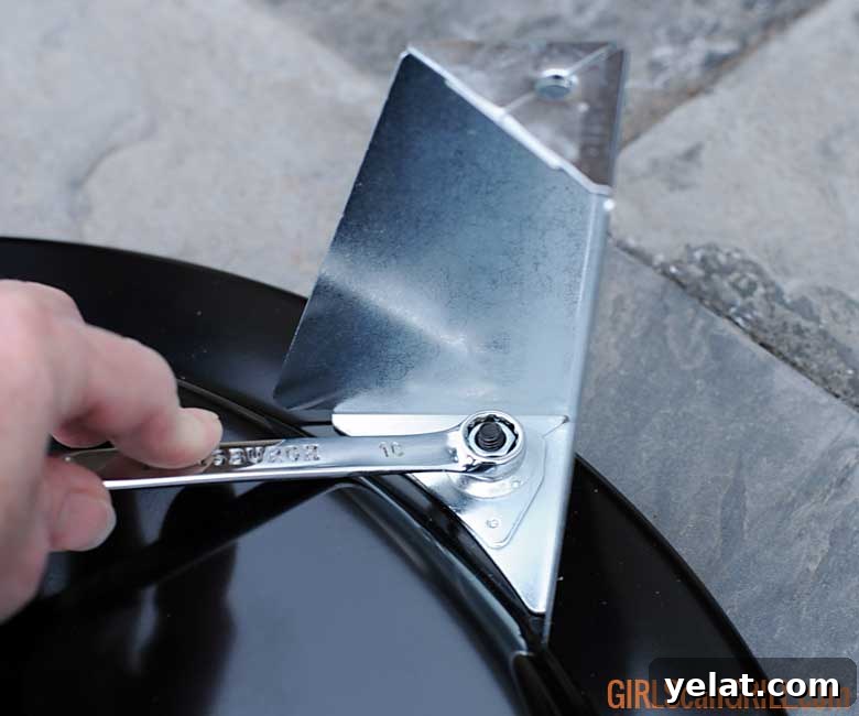 Barrel House Cooker 18C Review: Features, Performance & Verdict 7 using a wrench to tighten legs to a grill