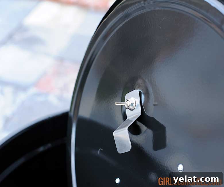 Barrel House Cooker 18C Review: Features, Performance & Verdict 9 back side of grill lid showing thermometer screw