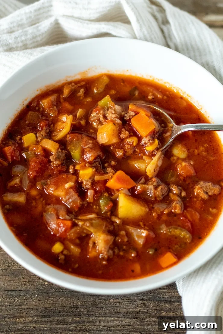 Hearty Vegetable Beef Soup Recipe with Savory Homemade Broth 3 Vegetable beef soup in serving bowl with spoon.