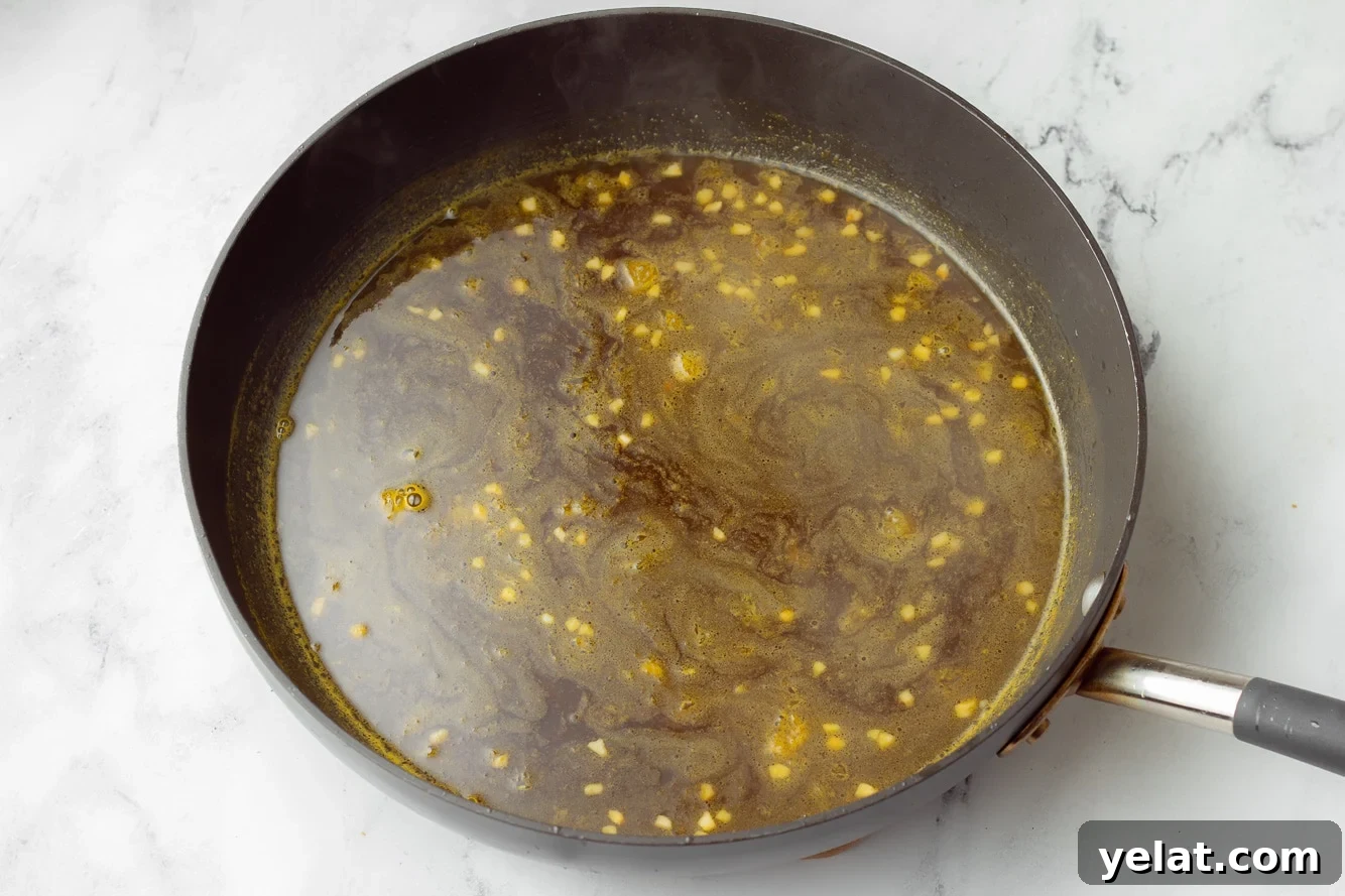 orange sauce for orange tofu in a large black skillet.