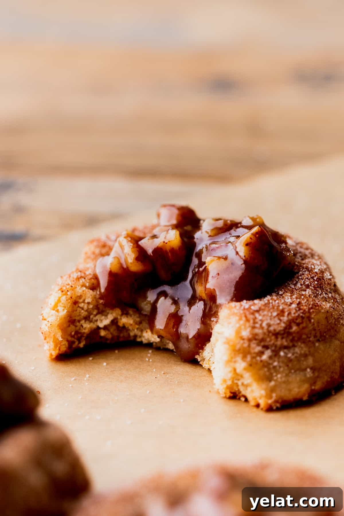 Pecan Pie Cookie Recipe: Crispy, Gooey Mini Pies 3 Side view of pecan pie cookie with a bite missing.