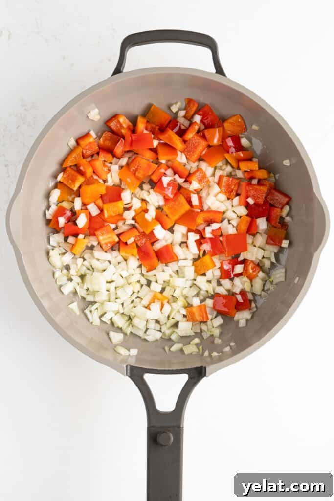 onions and peppers in a pan