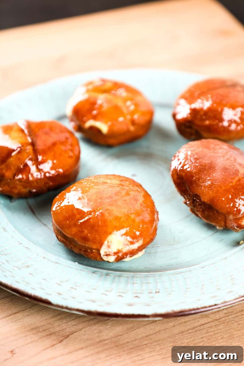 Crème Brûlée–Filled Donuts: Decadent Custard-Stuffed Doughnuts 5 5 doughnuts on a plate with vanilla cream filling and a creme brulee topping.