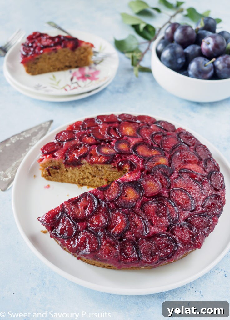 Sticky Plum Upside-Down Cake Recipe for Fall Baking 3 Plum cake with slice removed.