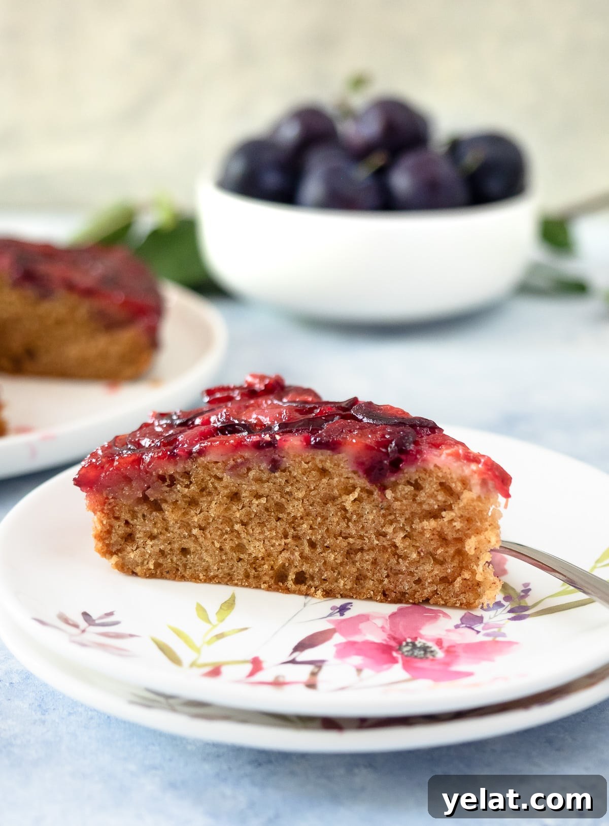 Sticky Plum Upside-Down Cake Recipe for Fall Baking 5 Slice of plum cake on dish.