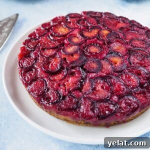 Sticky Plum Upside-Down Cake Recipe for Fall Baking 6 Plum upside-down cake on white plate.