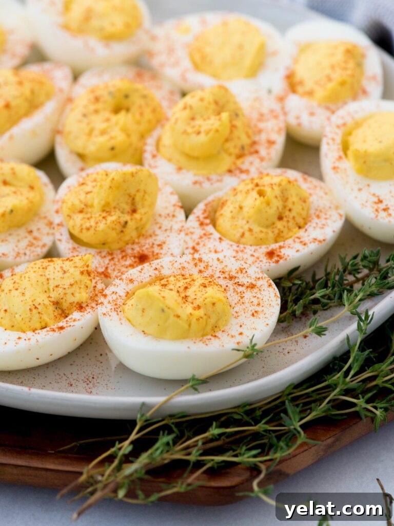 Creamy Deviled Eggs with Dijon Mustard and Fresh Herbs 2 Tray of deviled eggs ready to serve with paprika sprinkled over the top.