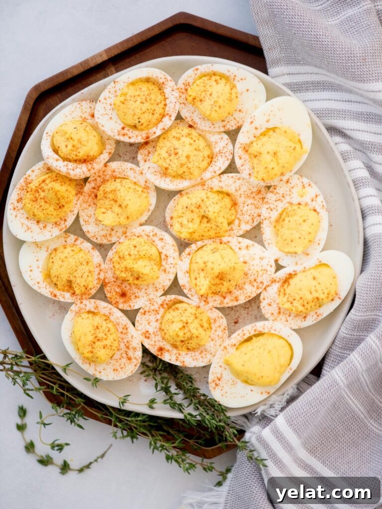 Creamy Deviled Eggs with Dijon Mustard and Fresh Herbs 9 Top view of a platter filled with paprika sprinkled deviled eggs.