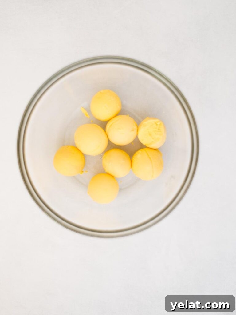 Creamy Deviled Eggs with Dijon Mustard and Fresh Herbs 5 cooked egg yolks added to a mixing bowl.