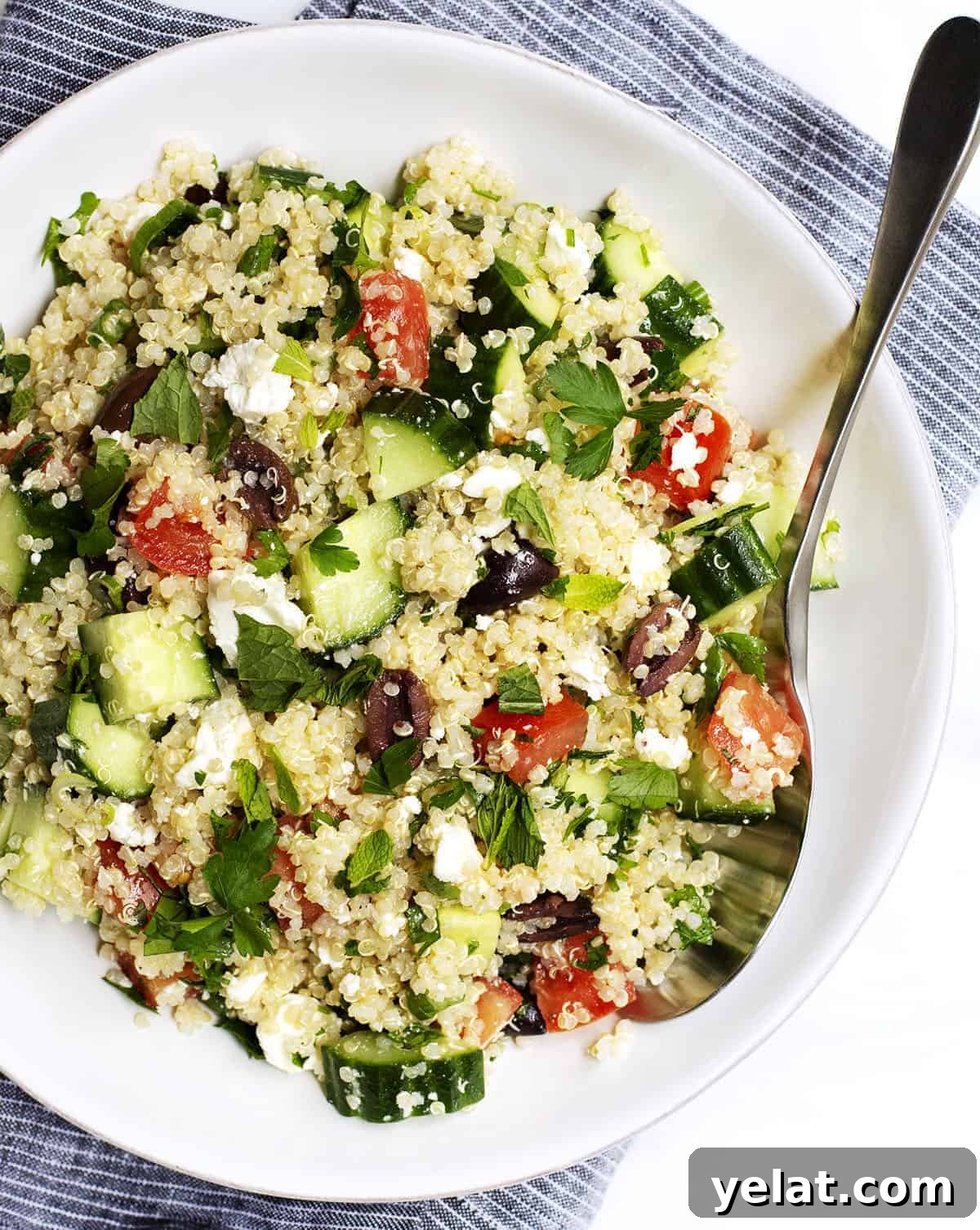 Quinoa Tabbouleh Salad Recipe: Fresh Mediterranean Grain Bowl 2 Quinoa Tabbouleh Salad served in a white bowl with stainless spoon