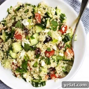 Quinoa Tabbouleh Salad Recipe: Fresh Mediterranean Grain Bowl 6 Quinoa Tabbouleh Salad served in a white bowl with stainless spoon