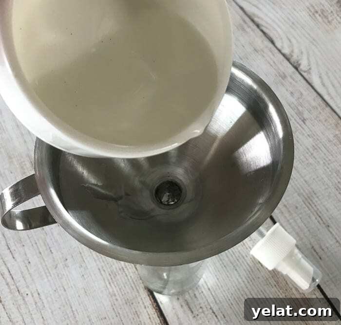 Make-Your-Own Before You Go Toilet Spray: Poo-Pourri Recipe 4 Pouring witch hazel into a bottle