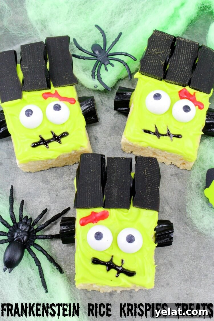 Three Frankenstein Monster Rice Krispies Treats with green spider webs and black spiders.