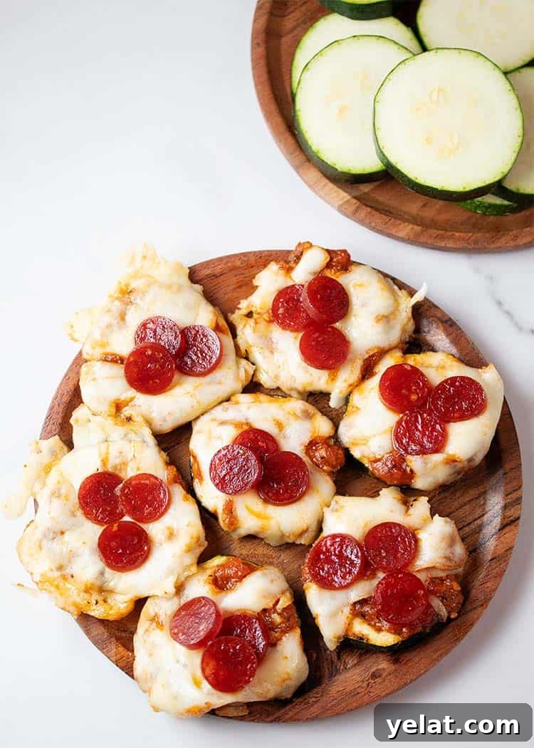 Zucchini Mini Pizzas: Bite-Sized Low-Carb Pizza Bites 2 overhead view of seven zucchini pizza bites on a wooden plate ready to serve