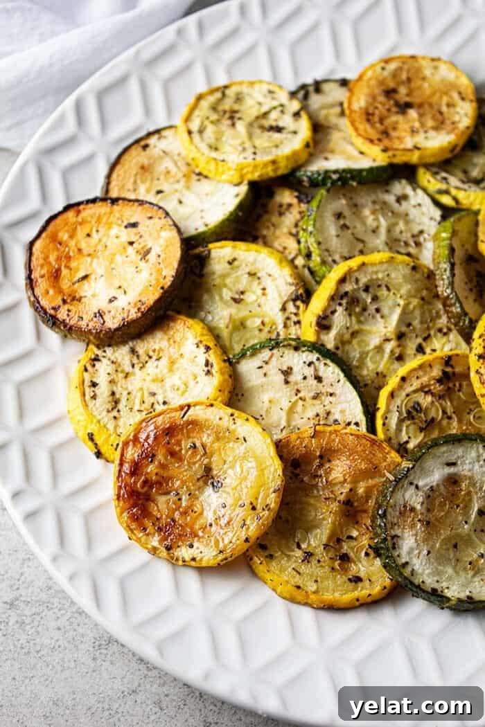 Zucchini Mini Pizzas: Bite-Sized Low-Carb Pizza Bites 10 overhead view of oven baked roasted zucchini and squash on a white serving dish