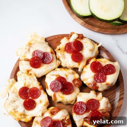 overhead view of seven zucchini pizza bites on a wooden plate ready to serve