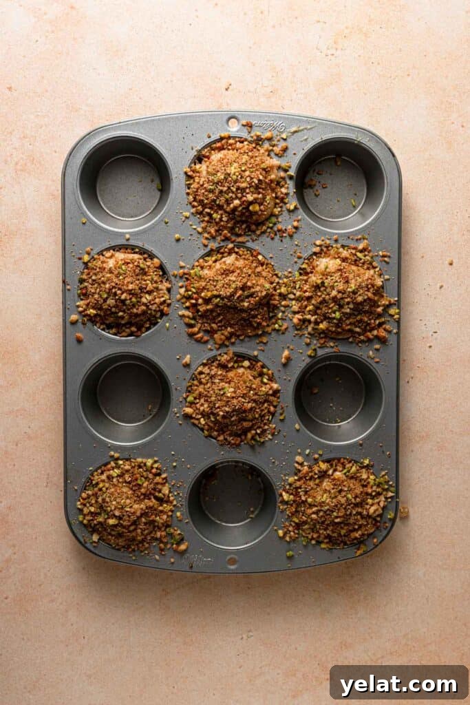 Baklava Muffins: Mediterranean Dessert with Honey, Nuts & Phyllo 8 A muffin pan with muffins batter.
