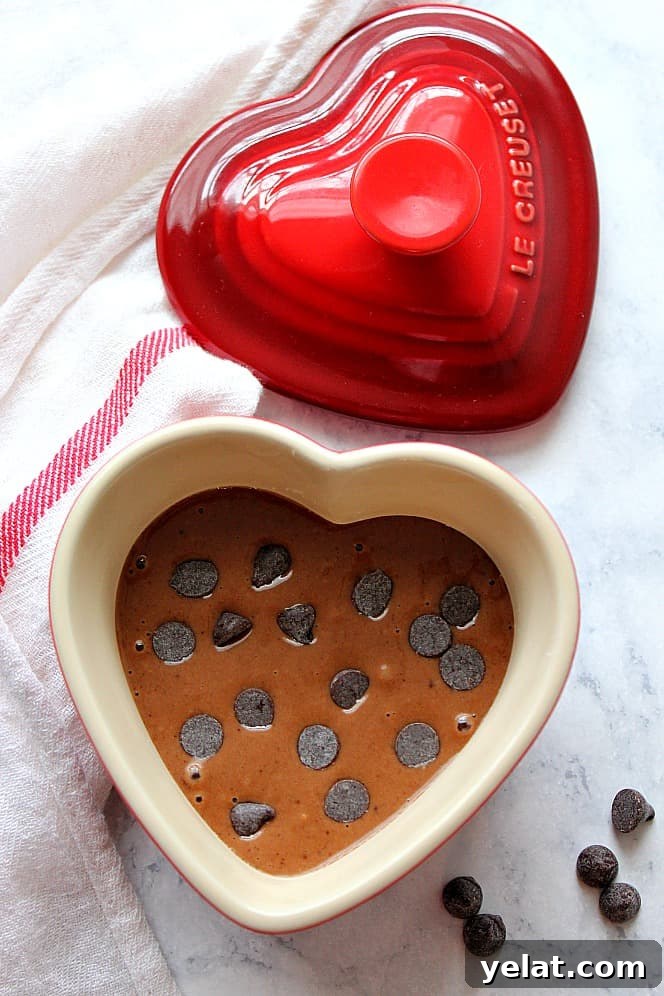 Chocolate Mug Cake for Two Recipe - fluffy and soft chocolate cake cooked in microwave! Perfect little treat that comes together in just under 5 minutes. heart shaped ramekin with chocolate cake batter