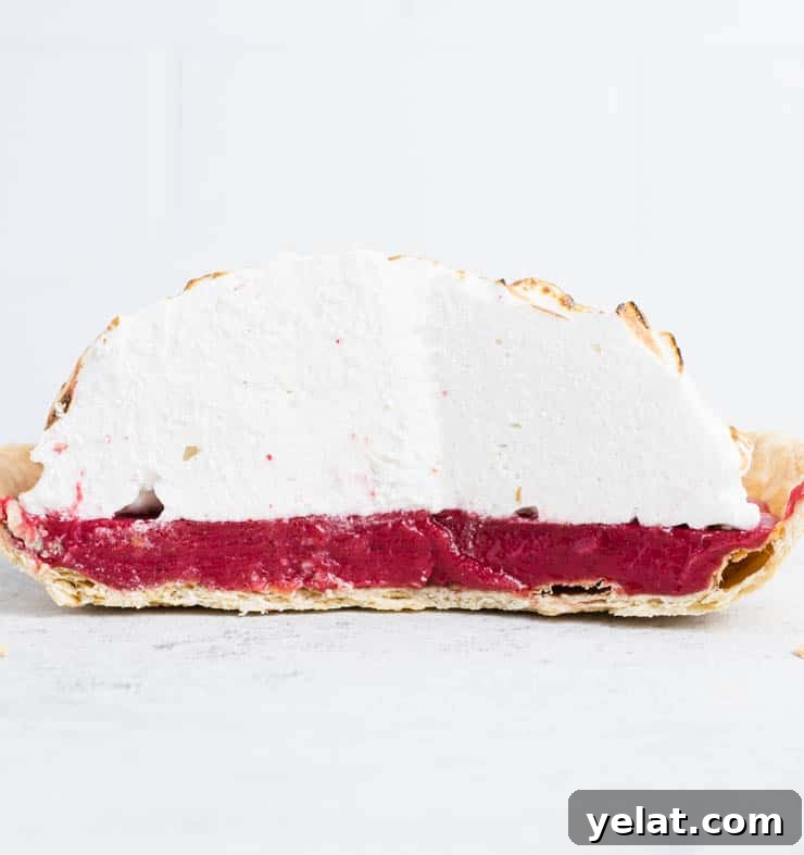 Flaky Pie Crust Recipe: A Complete Step-by-Step Guide 9 Cranberry meringue pie cut in half to show the flakiness of the pie crust.
