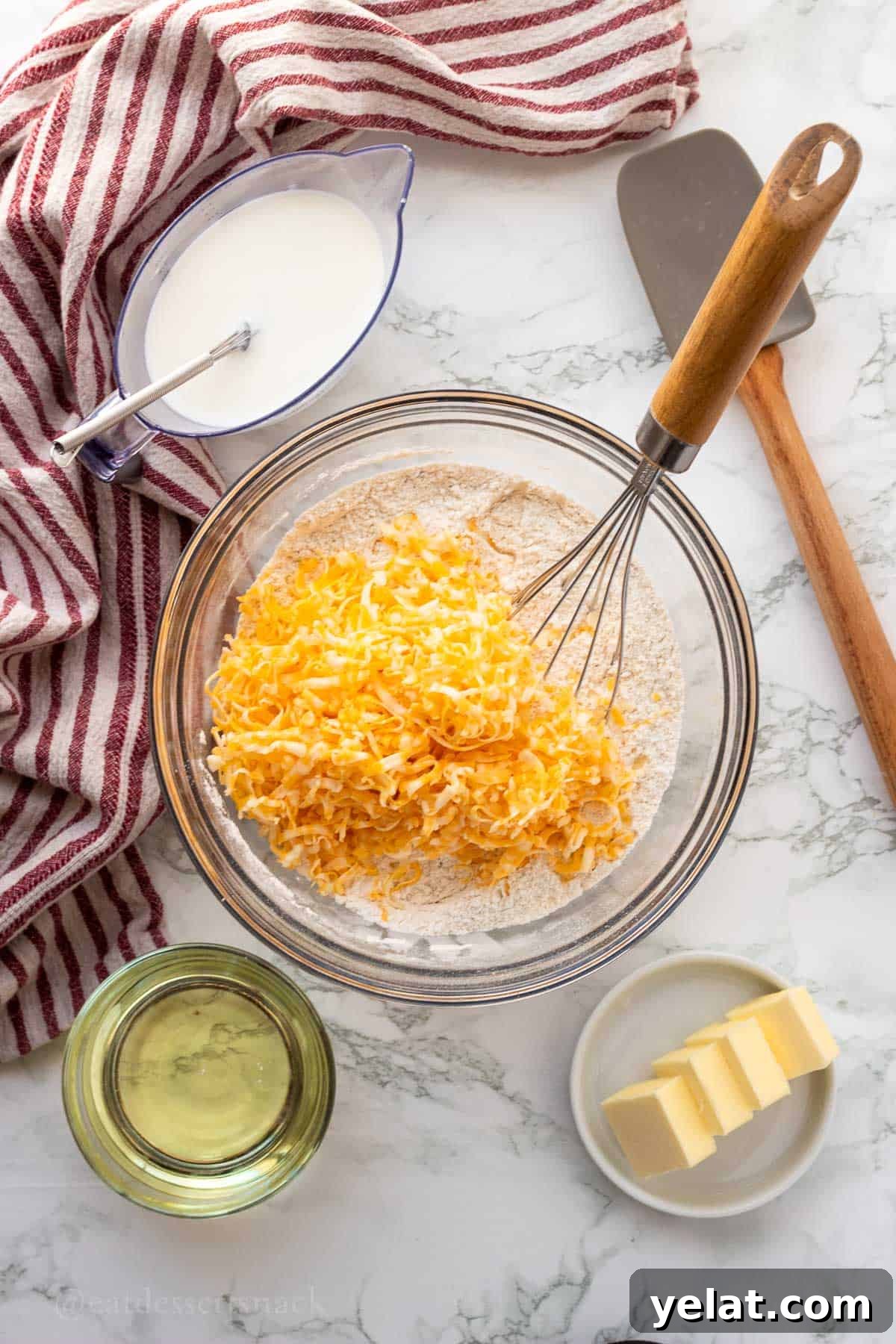 Garlic Cheddar Drop Biscuits Recipe: Quick Savory Biscuits 6 Shredded cheese and dry ingredients in glass bowl.