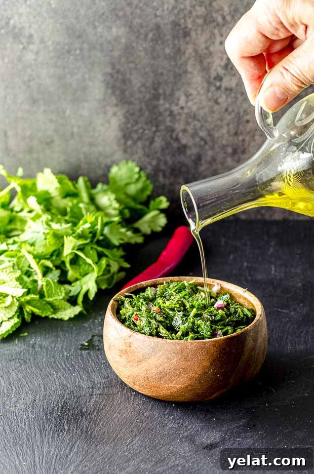 Chimichurri Sauce Recipe: Authentic Argentine Fresh Herb Sauce 4 Pouring oil on a wood bowl of Chimichurri