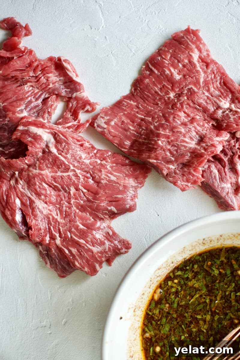 Carne Asada Marinade for Beef Fajitas and Tacos 6 Beef Loin Flap Meat Steak and the Carne Asada Fajita Marinade in a bowl.