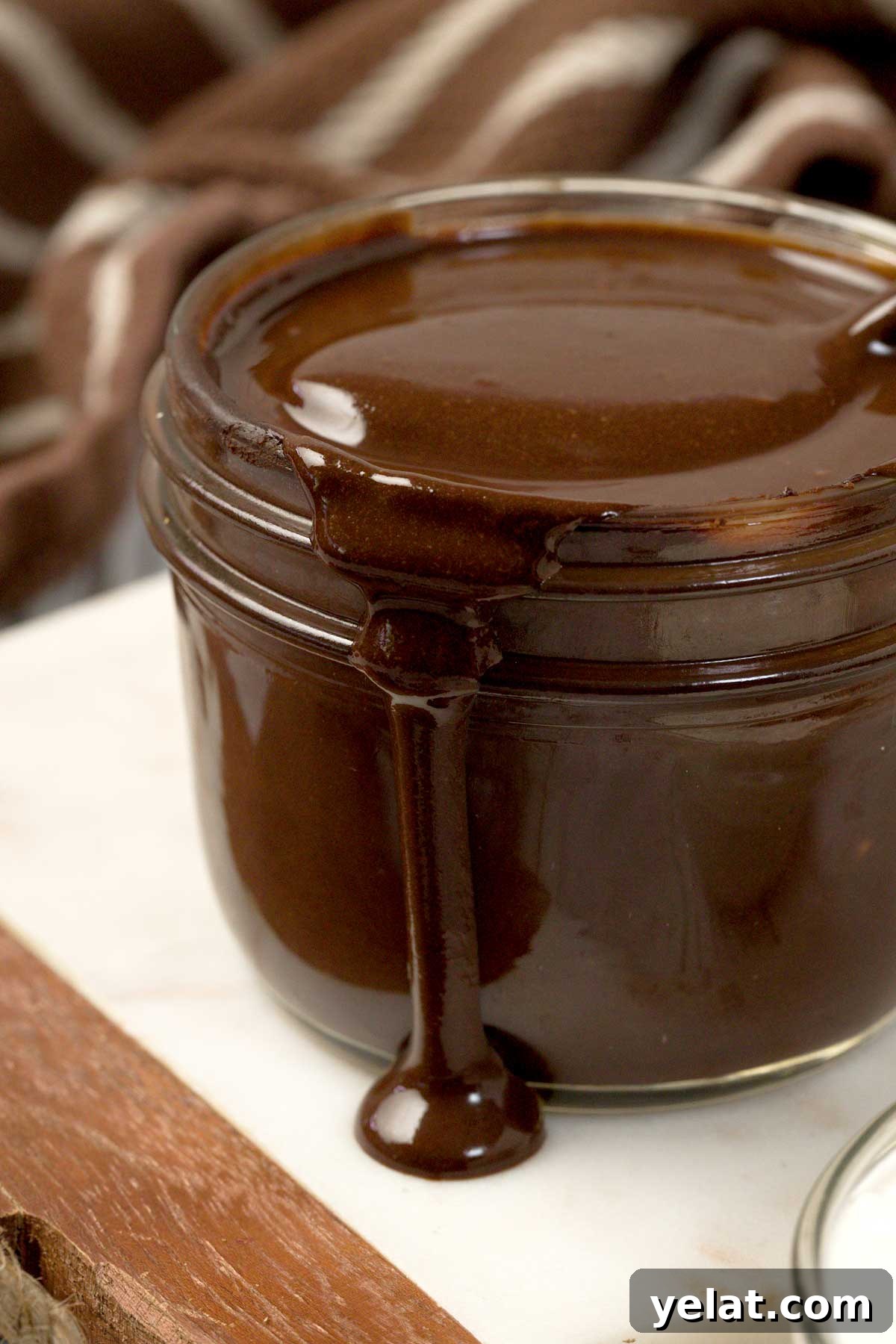 Light Protein Cottage Cheese with Chocolate Sauce Recipe 3 A close-up of protein cottage cheese chocolate sauce dripping down the side of a mason jar.