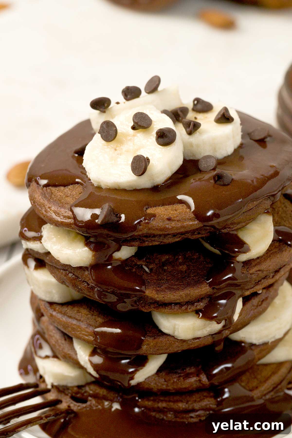 Light Protein Cottage Cheese with Chocolate Sauce Recipe 4 Stack of chocolate protein powder pancakes with cottage cheese on a plate.