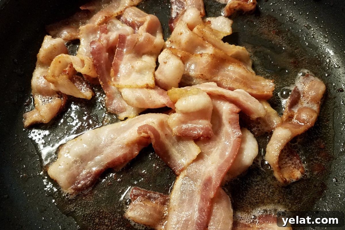 Grandma’s Crispy Bacon Brussels Sprouts Recipe 3 Cooking bacon in a skillet.