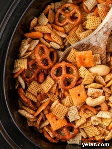 A slow cooker or crock pot insert filled with lightly browned Chex Mix.