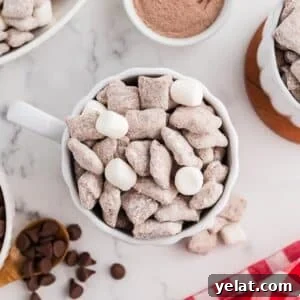 A mug of muddy buddies, dotted with random mini marshmallows.