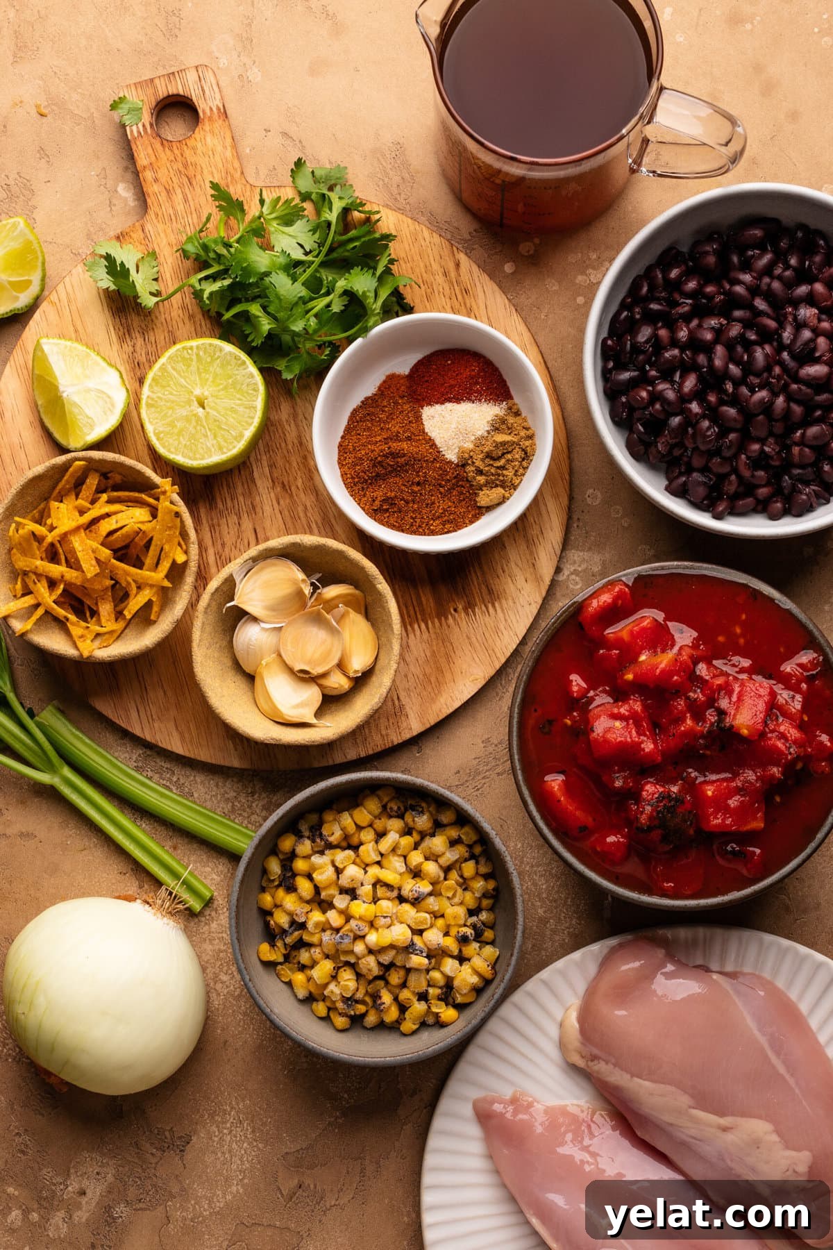 Hearty Chicken Taco Soup Recipe for Cozy Weeknight Dinners 3 Ingredients for chicken taco soup arranged in small bowls on a tan background, while some of the ingredients are on a round wooden cutting board.