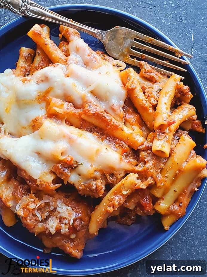 easy instant pot baked ziti with ricotta on a blue plate with a fork