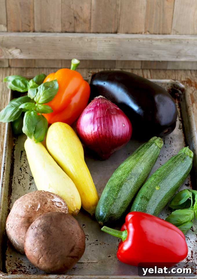 Grilled Vegetable Sandwich with Fresh Mozzarella and Basil Aioli 3 One eggplant, two yellow squash, one bell peppers, two zucchinis, one red onion and two portobello mushrooms in a baking sheet.