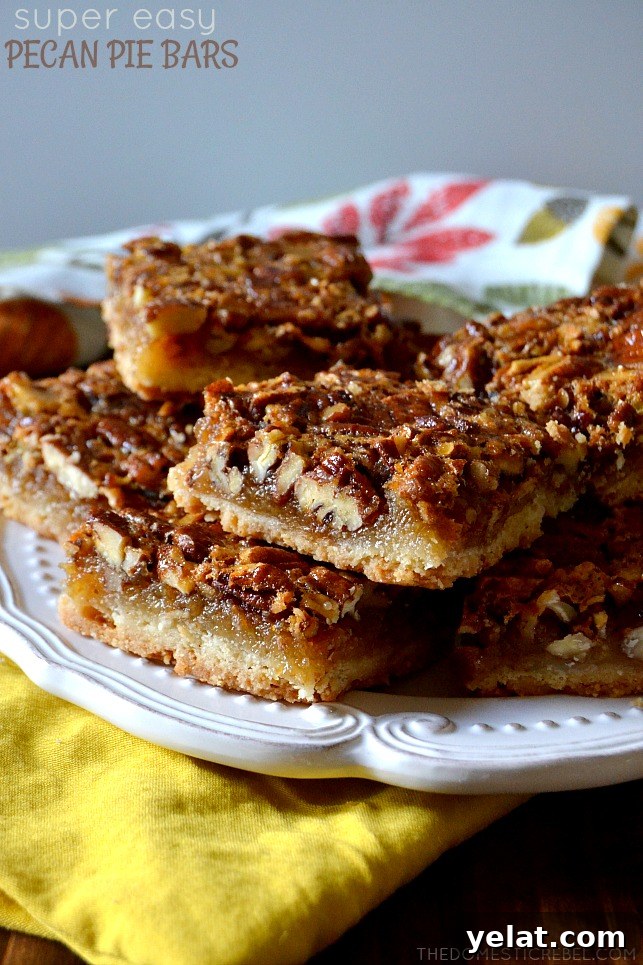 Quick Last-Minute Thanksgiving Desserts to Impress Guests 13 pecan pie bars arranged in a stacked formation on a white plate on top of a floral dish towel