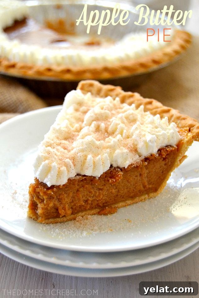 apple butter pie slice topped with whipped cream swirls on a stack of mini white plates