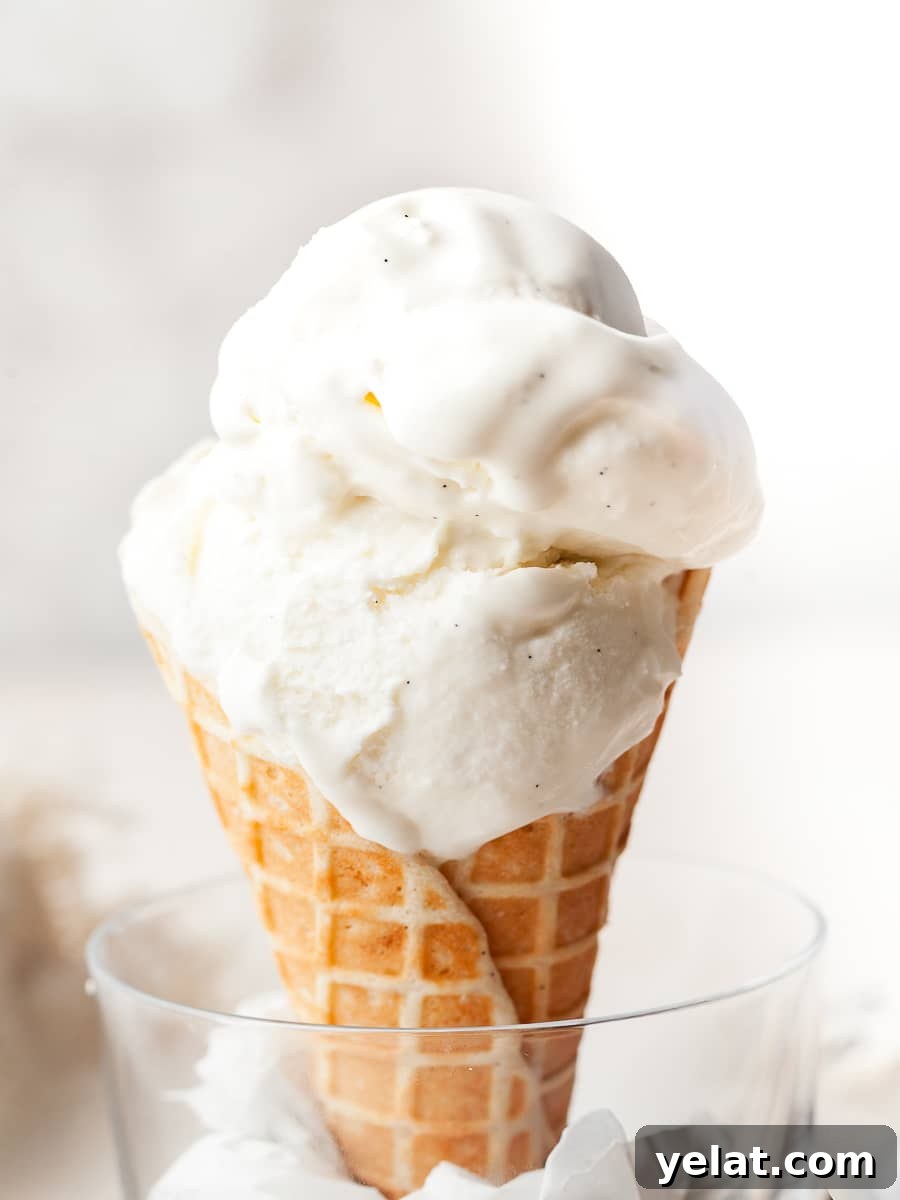 gluten free no churn vanilla ice cream on top of a gluten free waffle cone