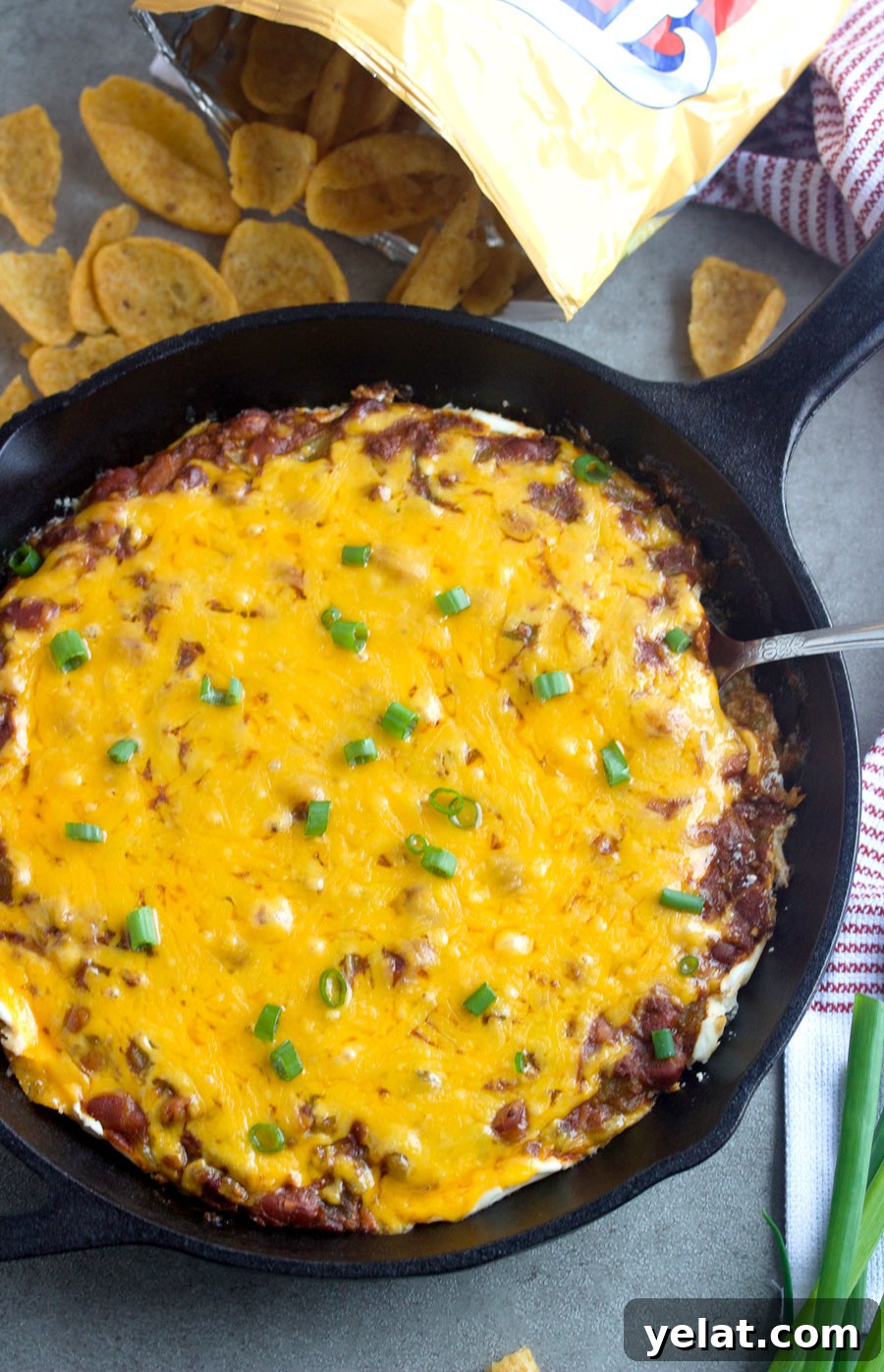 Fritos Chili Cream Cheese Dip Recipe — Crowd-Pleasing Party Dip 2 Overhead shot of Fritos chili cream cheese dip with a bag of Fritos scoops next to it.