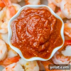 Homemade shrimp cocktail recipe served with delicious homemade cocktail sauce in a white bowl.