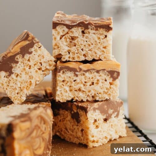 A small stack of chocolate covered rice krispie treats.