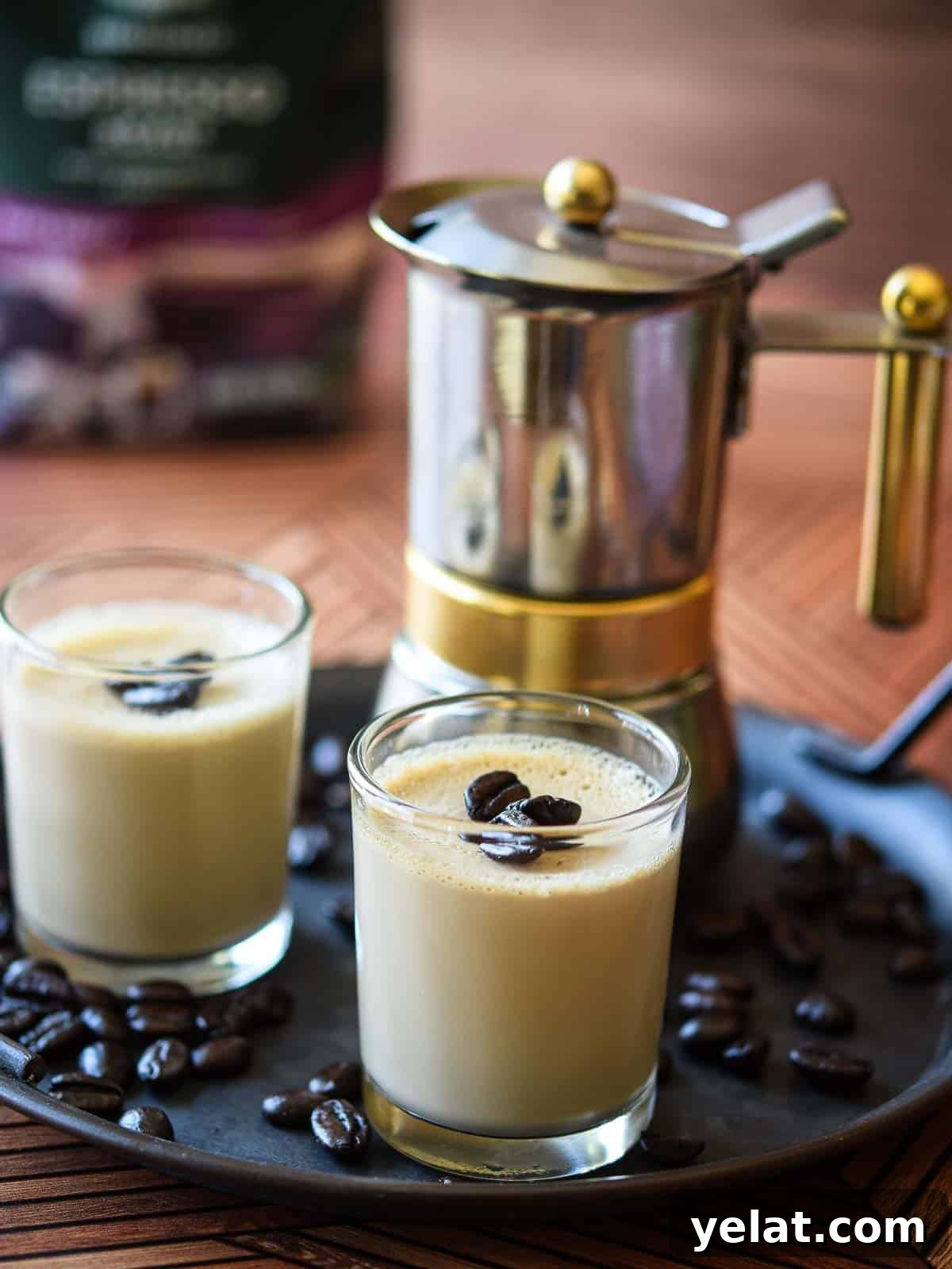 Espresso panna cotta in small glass jars with coffee in the background.