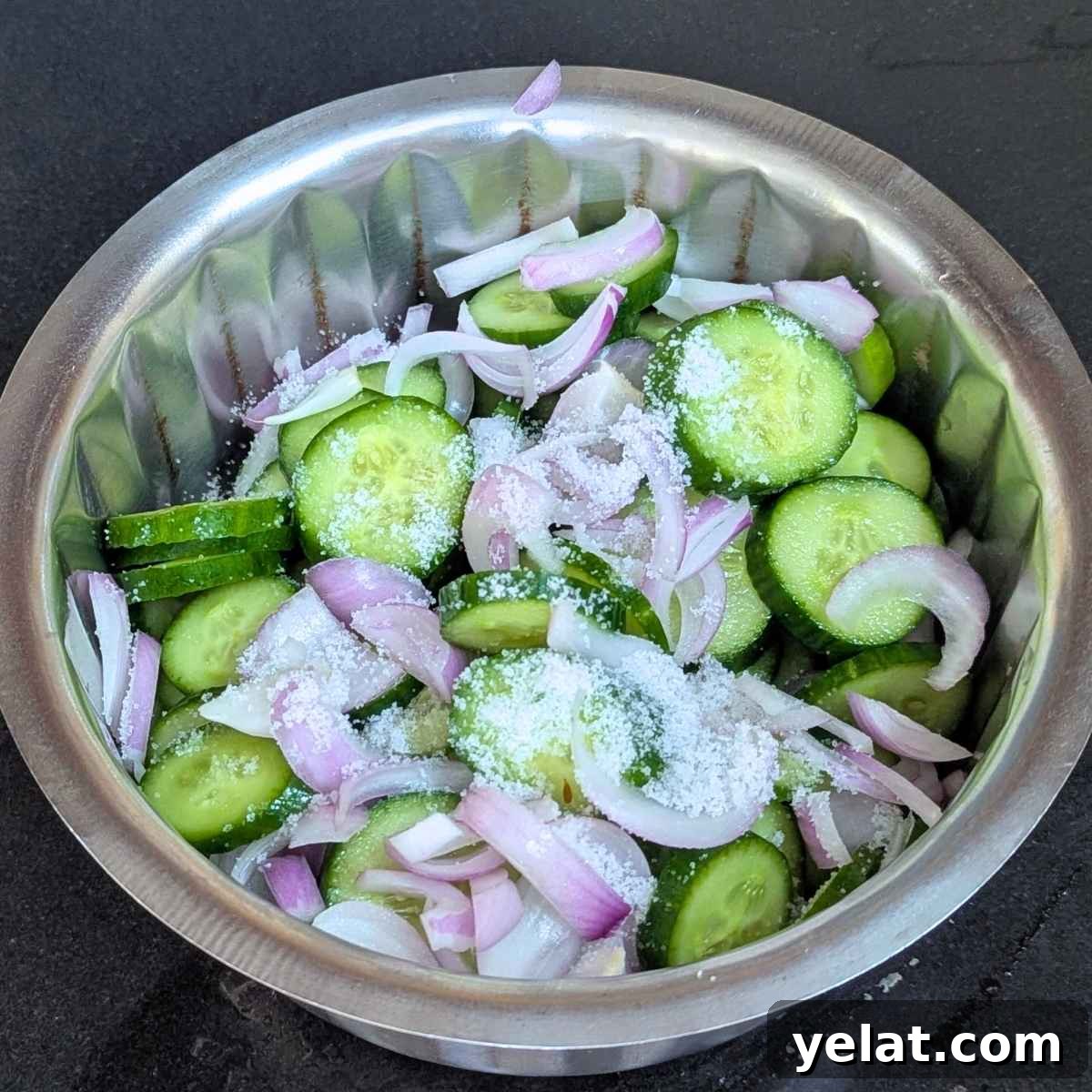 Sliced cucumber and onion mixed with salt