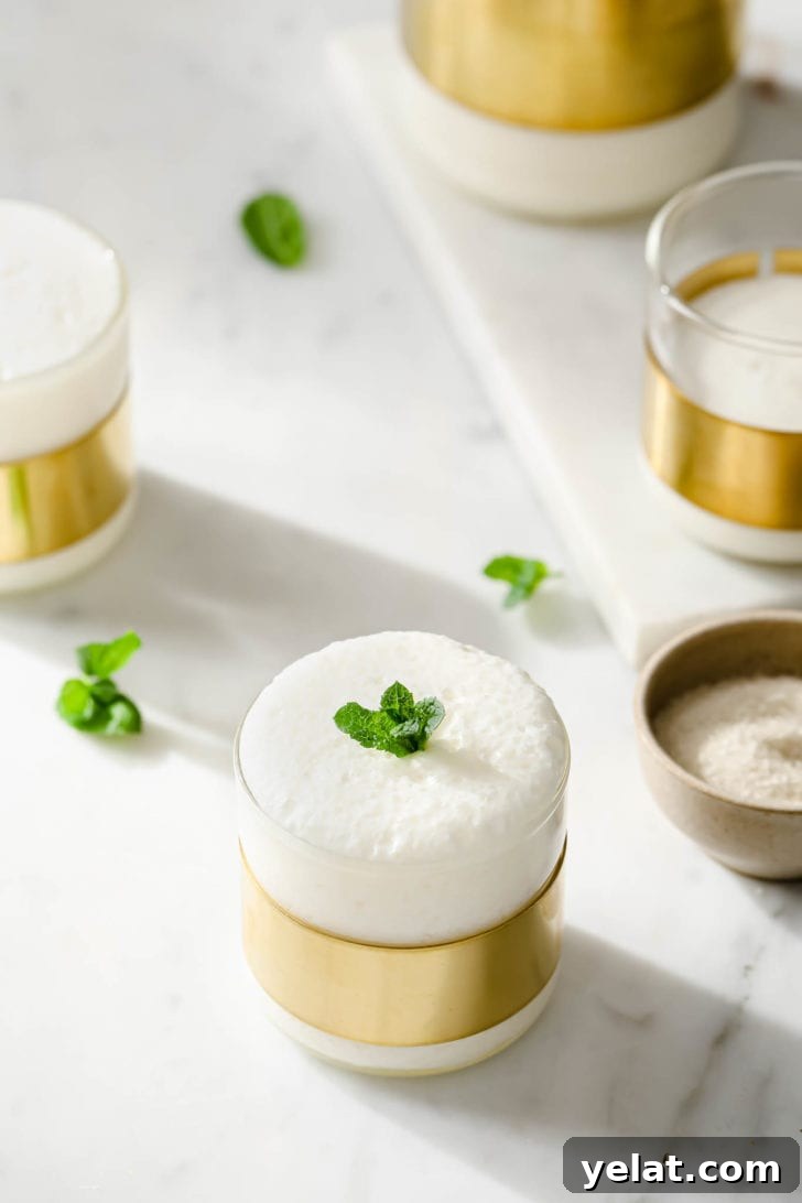 Authentic Sweet Lassi Recipe: Creamy Indian Yogurt Drink Guide 12 Lassi in glasses topped with fresh. mint for garnish.