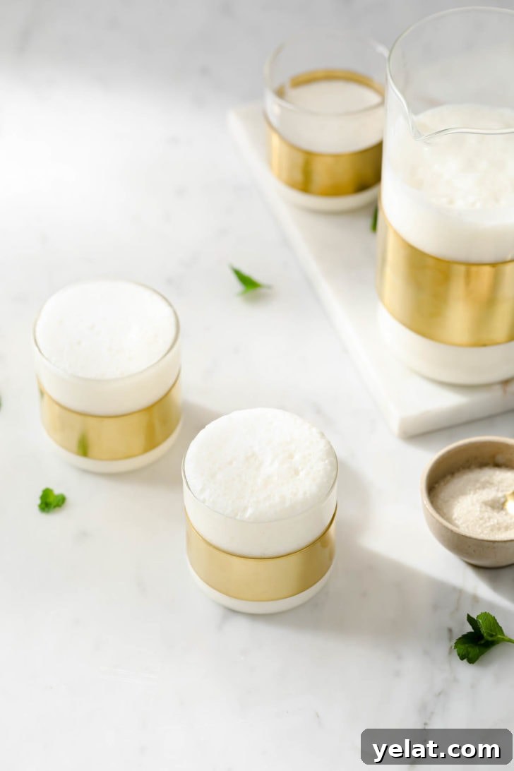 Authentic Sweet Lassi Recipe: Creamy Indian Yogurt Drink Guide 4 Lassi in glasses with a bowl of sugar on the side.