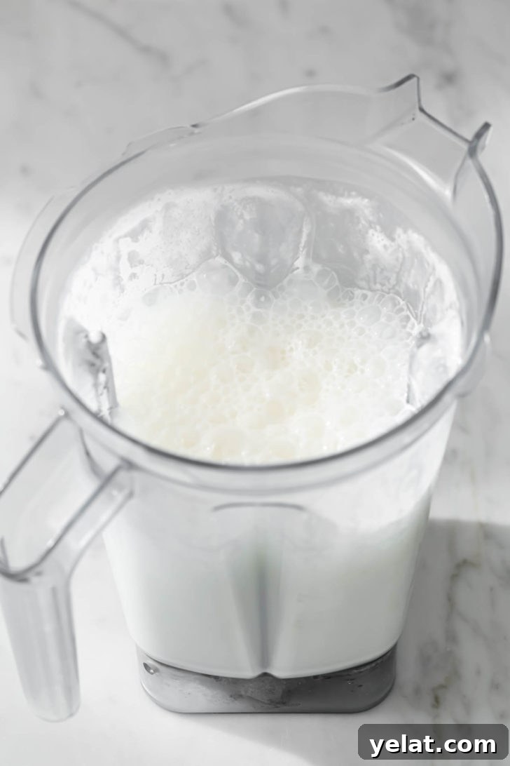 Authentic Sweet Lassi Recipe: Creamy Indian Yogurt Drink Guide 9 Lassi in a blender after being blended.