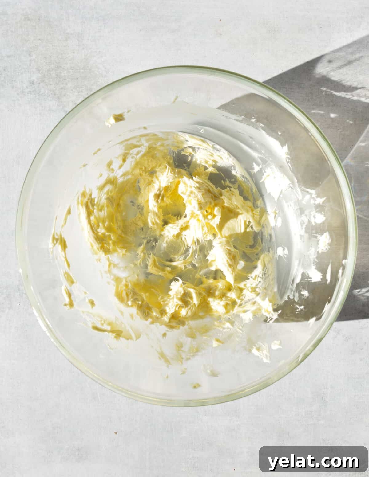 Silky Peppermint Buttercream Frosting Recipe for Cakes & Cupcakes 5 a bowl of creamed butter in it