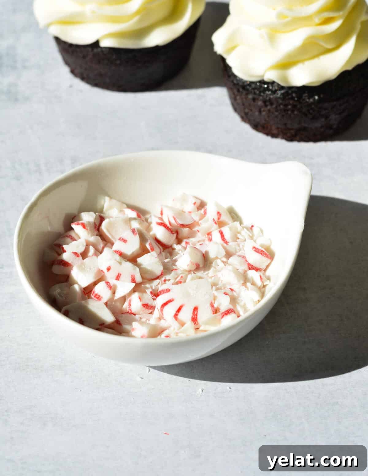 Silky Peppermint Buttercream Frosting Recipe for Cakes & Cupcakes 9 a bowl of crushed peppermints.