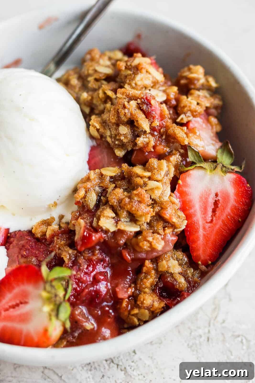 Strawberry crisp and ice cream in a bowl.