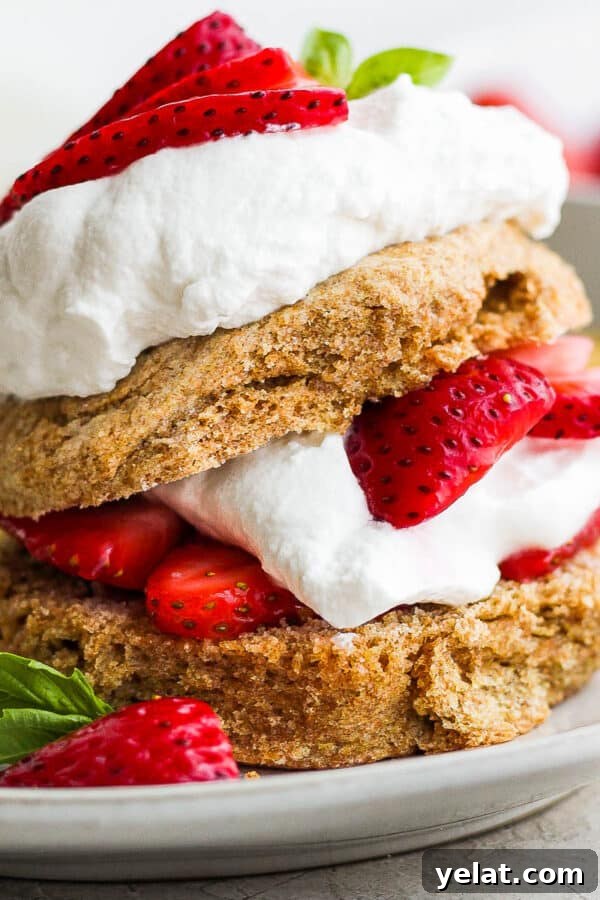 Healthy Strawberry Shortcake on a plate with basil garnish.